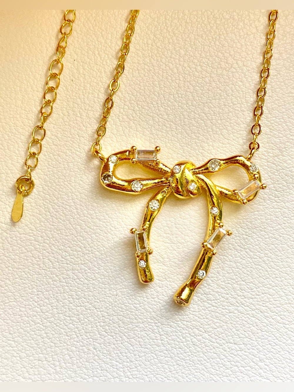 Gold bow necklace with clear rhinestones